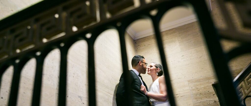 Bride and groom about to kiss in stairwell in Roosevelt Hotel wedding photo