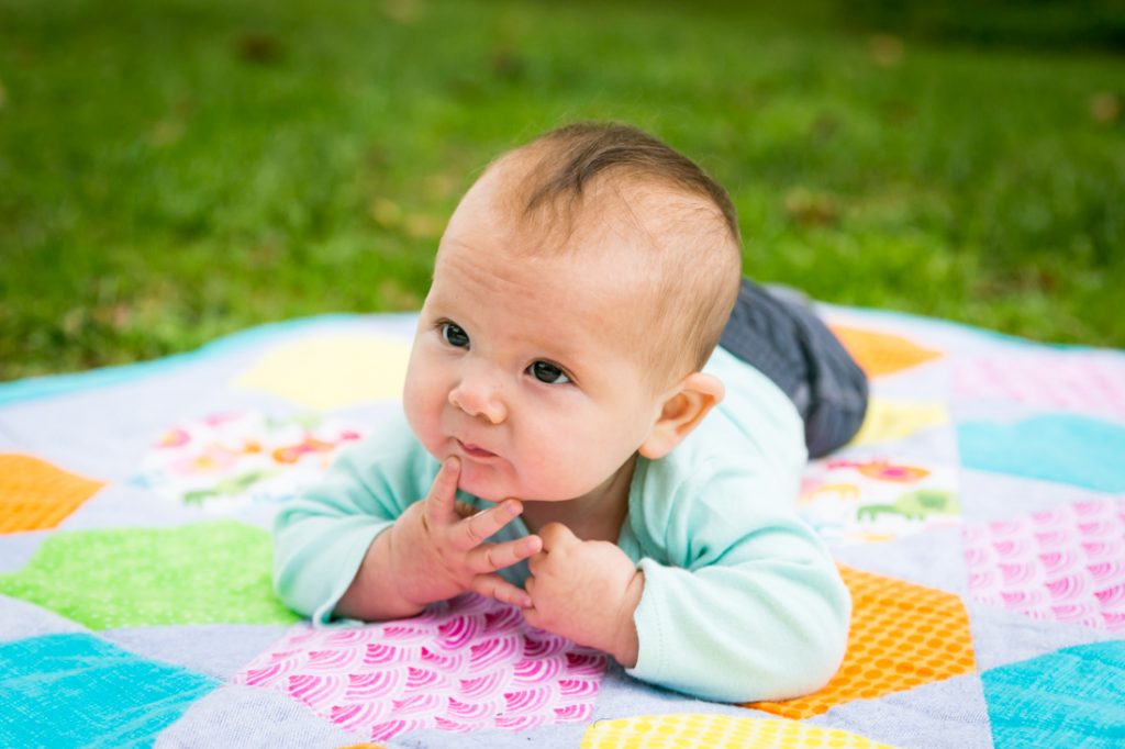 Baby on stomach on quilt by Brooklyn baby photographer, Kelly Williams