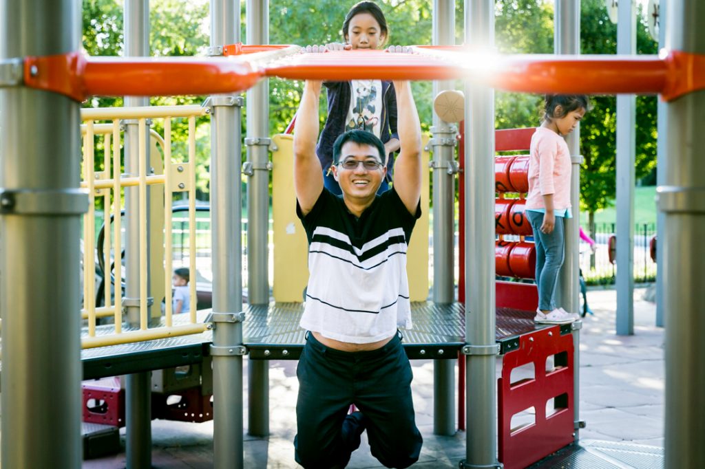 Father on jungle gym in Elmhurst Park