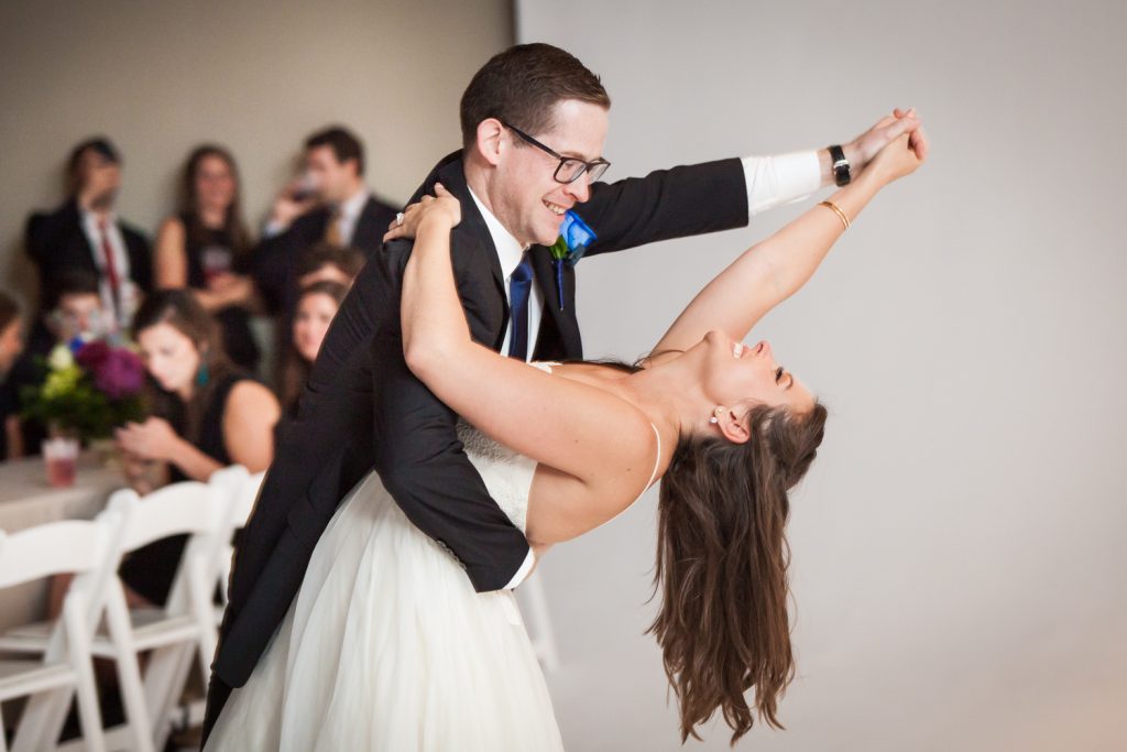 Groom dipping bride during first dance at a Bathhouse Studios wedding