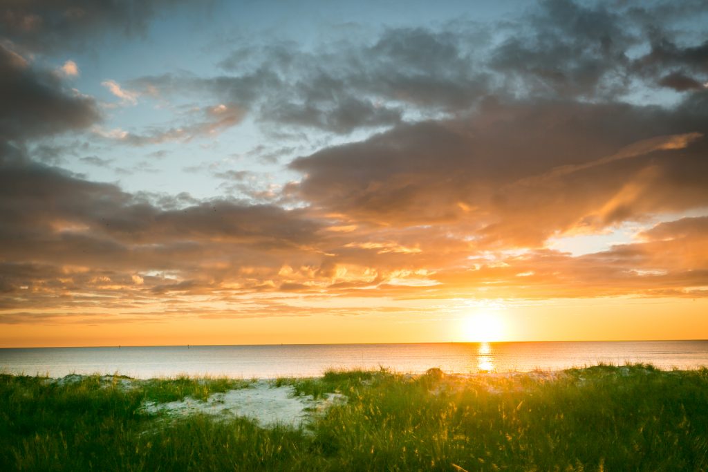 Sun setting across water for article on Honeymoon Island photos