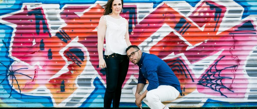 Couple in front of graffiti mural for a NYC wedding destination guide