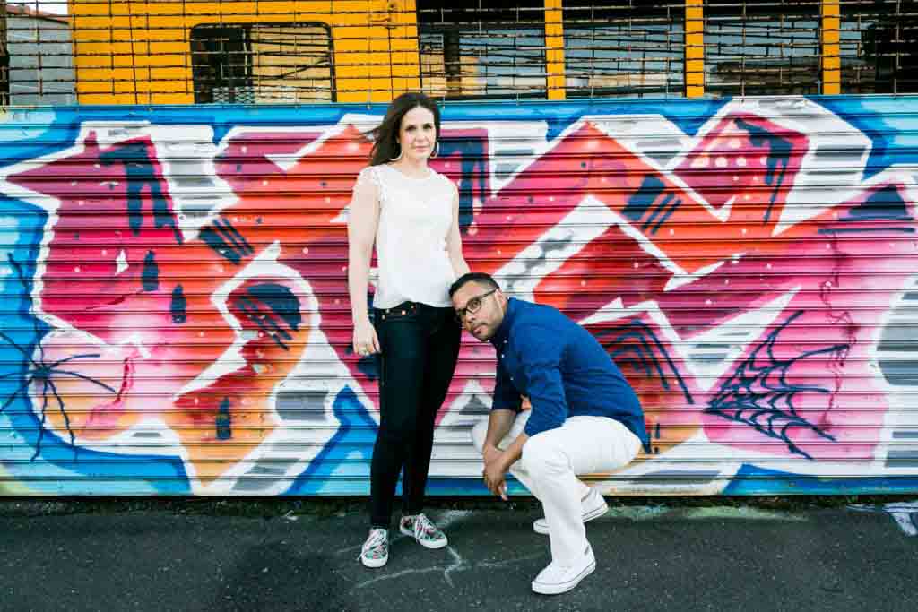 Couple in front of graffiti mural for a NYC wedding destination guide