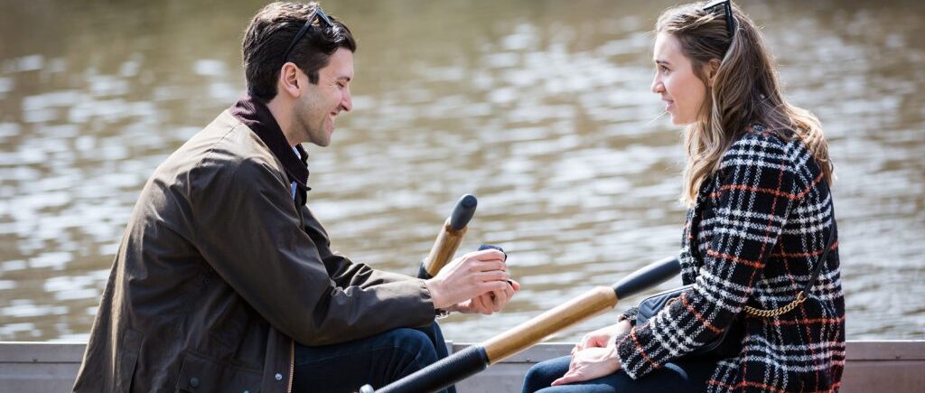Man in boat asking his girlfriend to marry him for an article on Central Park Lake proposal tips