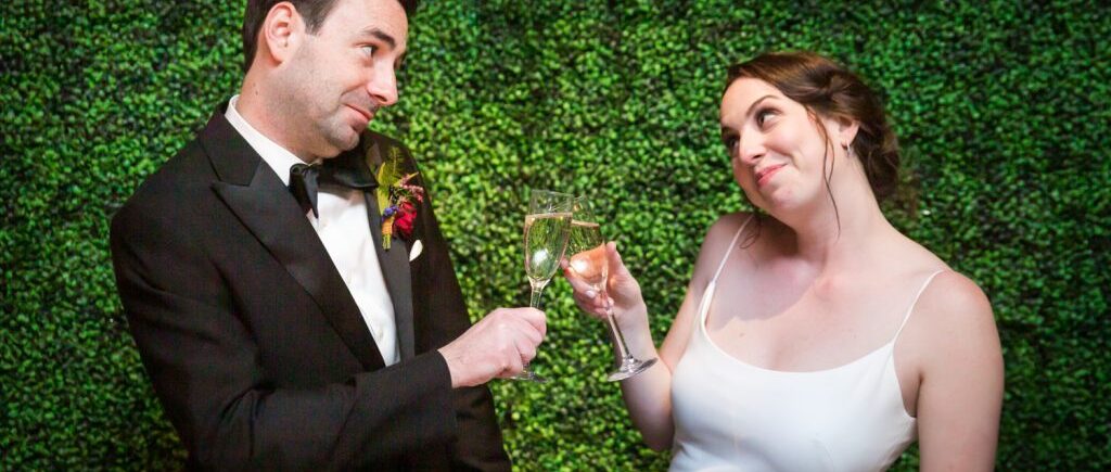 Bride and groom toasting champagne glasses at a Water Club wedding
