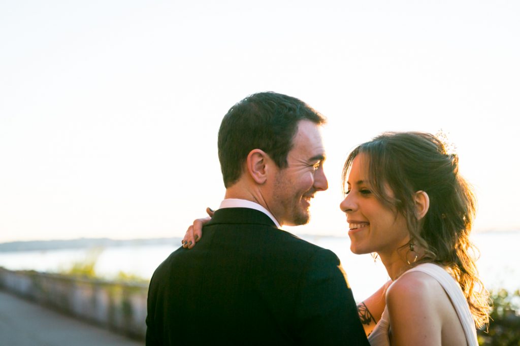 Bride and groom on Red Hook pier at sunset