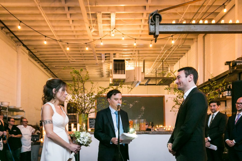 Bride and groom exchanging vows at an Atelier Roquette wedding