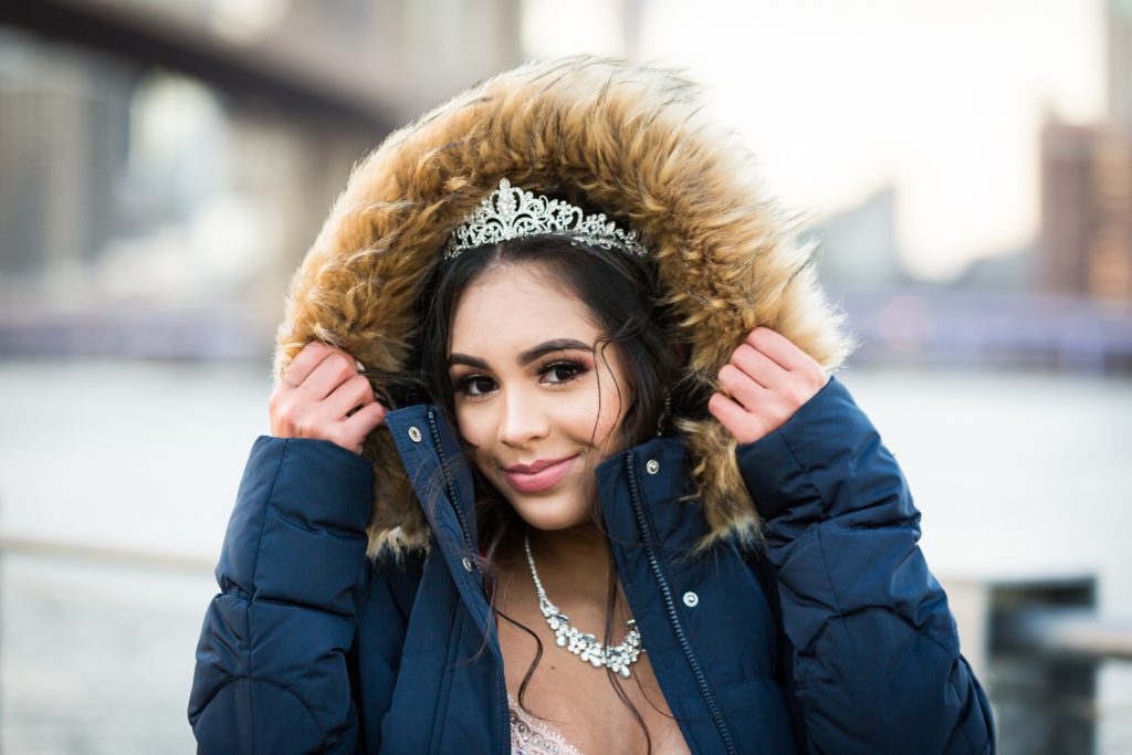 Girl wearing tiara and coat with fur hood for an article on cold weather portrait tips