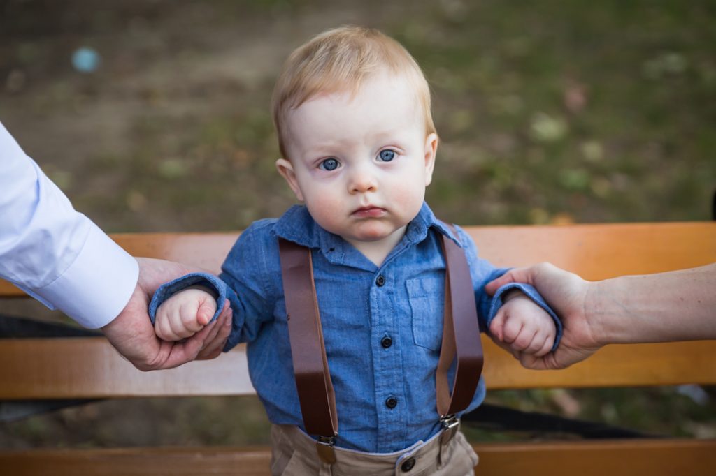 Color photo of little boy being held by arms