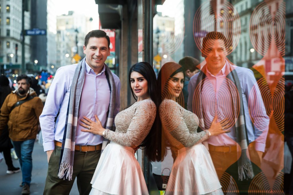 Color photo of couple reflected in store window