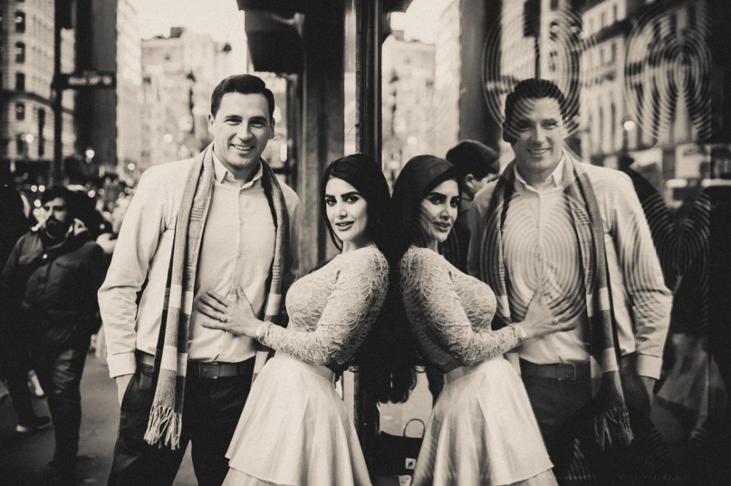 Black and white photo of couple reflected in store window