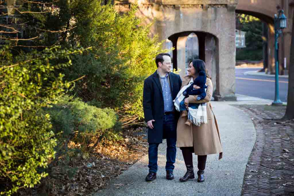 Forest Hills baby portrait of parents and baby walking on sidewalk