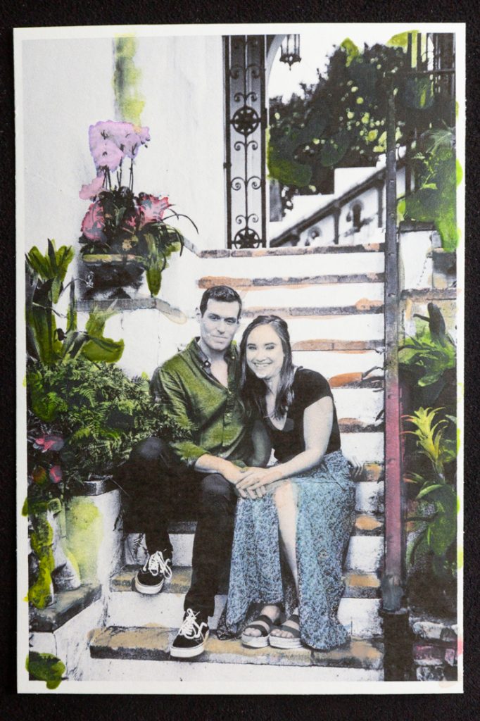 Hand-colored image of couple sitting on staircase