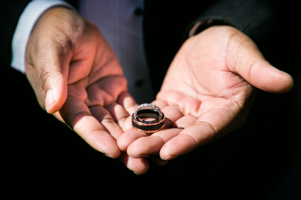 Man holding wedding rings in his hands