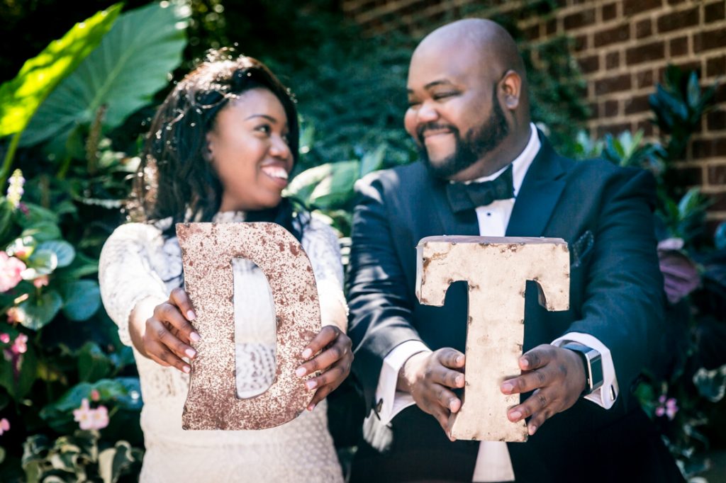 Bride and groom holding out D and T initials