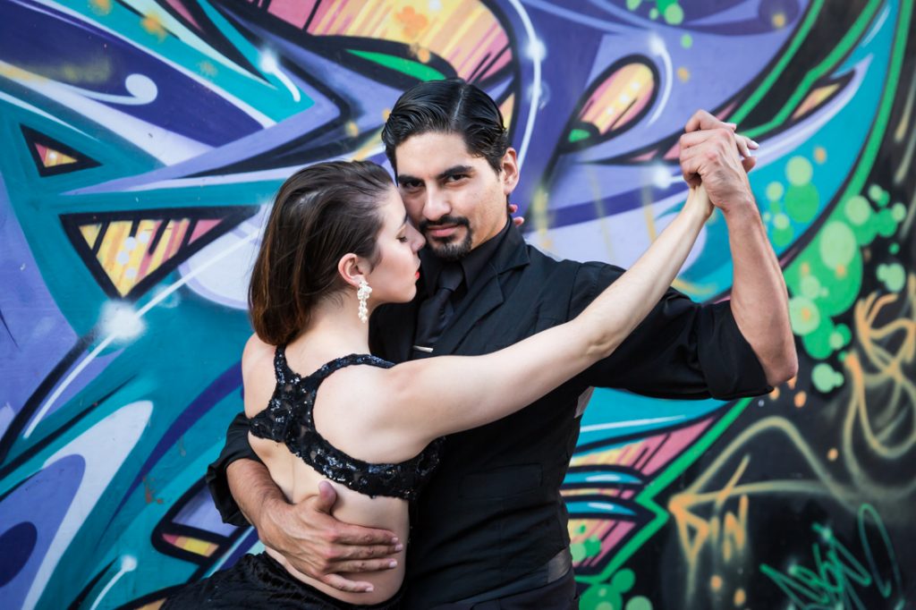 Tango dancers in front of graffiti wall for an article on hand-colored black and white images