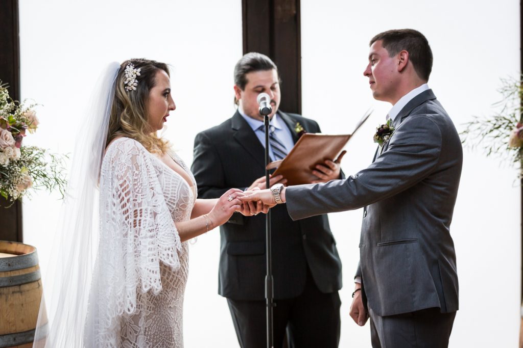 Brooklyn Winery wedding photos of bride putting ring on groom