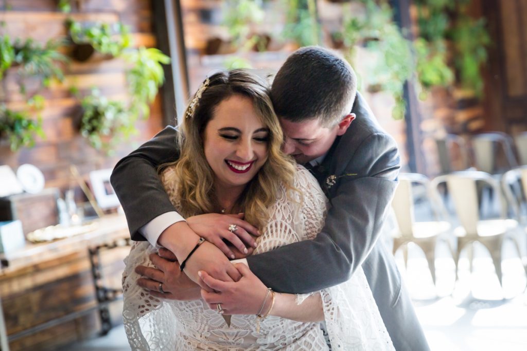 Groom hugging bride during first dance at Brooklyn Winery
