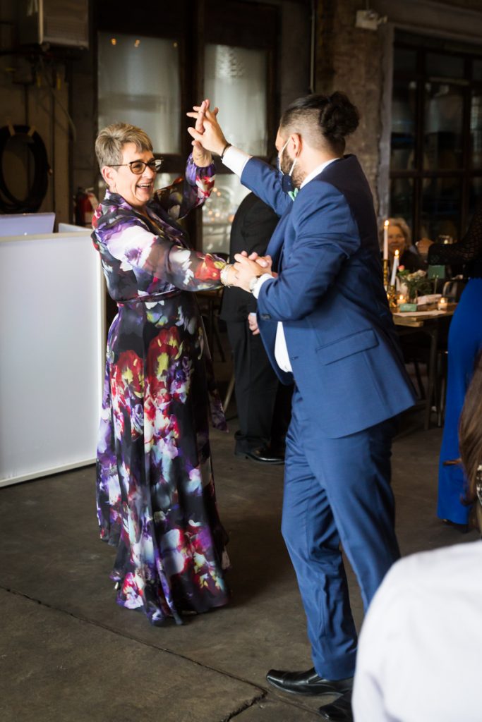 Mother of bride dancing with guest at wedding reception