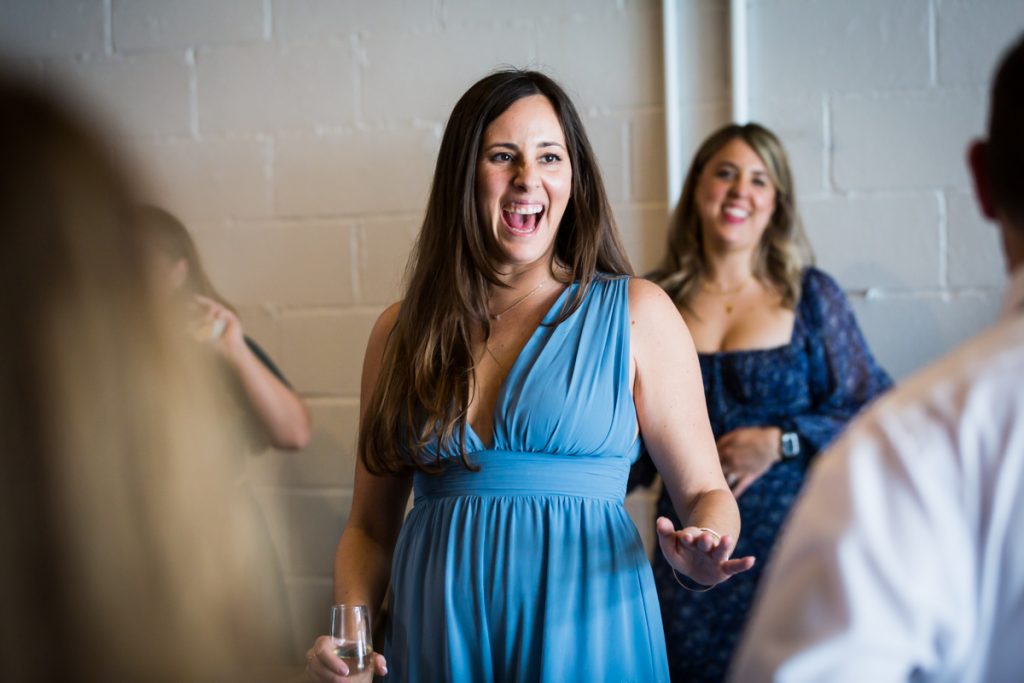 Female guest in blue dress dancing during Brooklyn Winery wedding reception