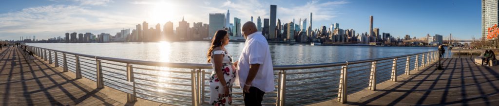 Panorama shot of couple along waterfront during a Long Island City maternity portrait session