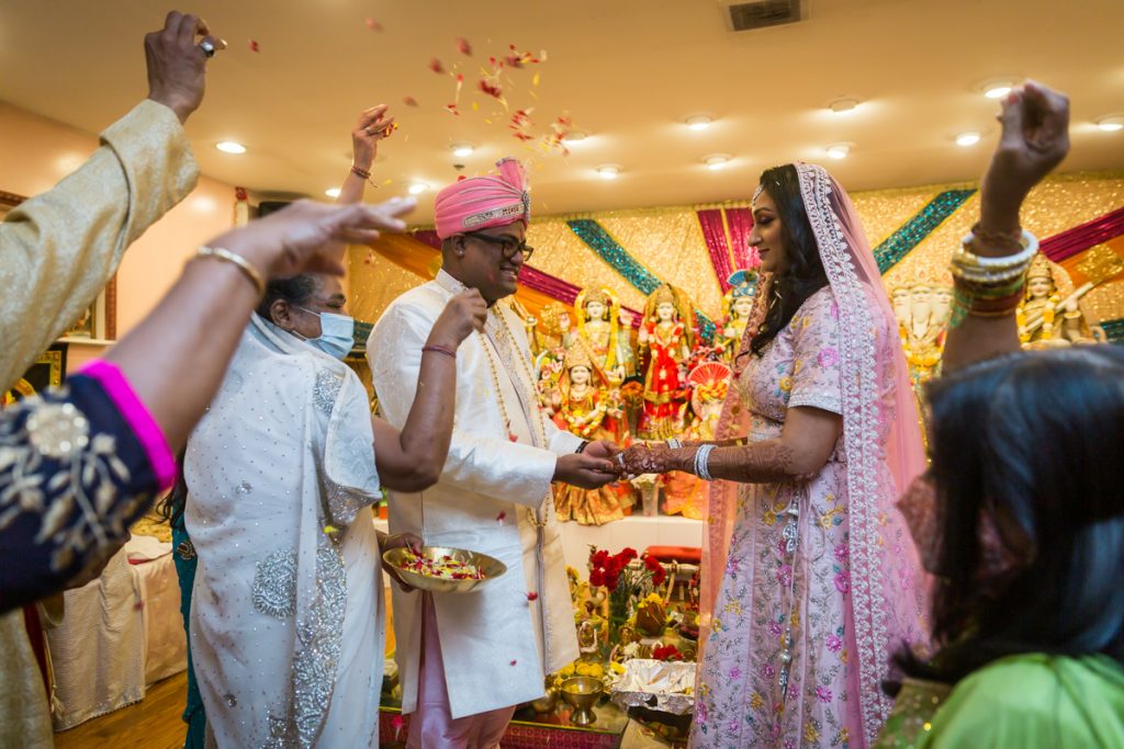 Sagai ceremony photos of family throwing rose petals at bride and groom