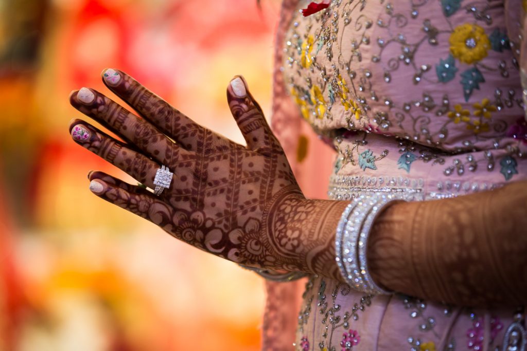 Hands of Indian bride covered in mehendi or henna