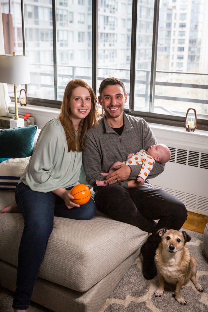 Upper West Side newborn portrait of parents holding newborn baby and mini basketball