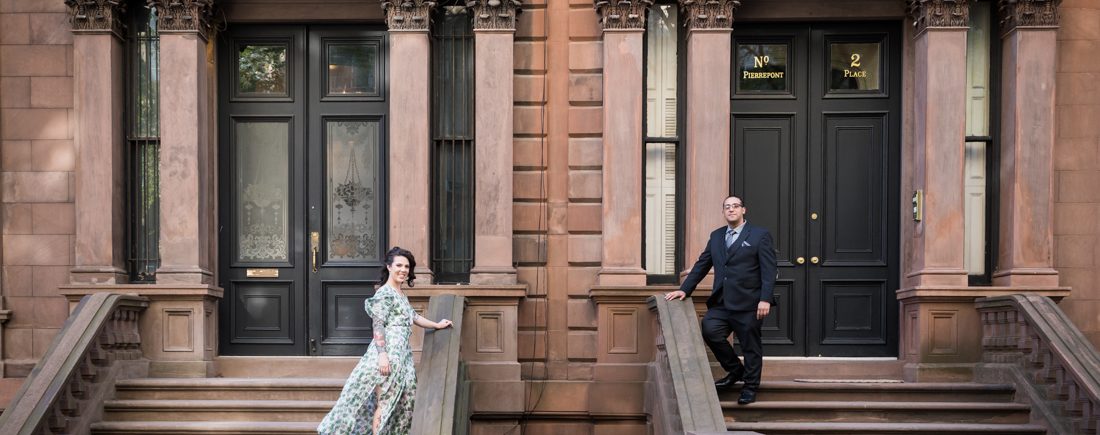 Couple standing on brownstone staircases
