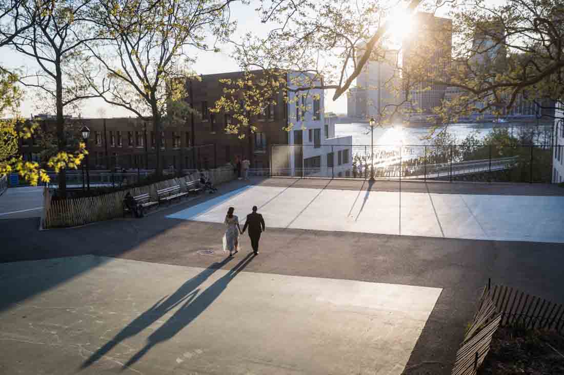 Shadows of couple walking across basketball court