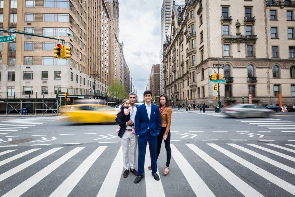 Family standing in a NYC crosswalk for an article on NYC family portrait location ideas