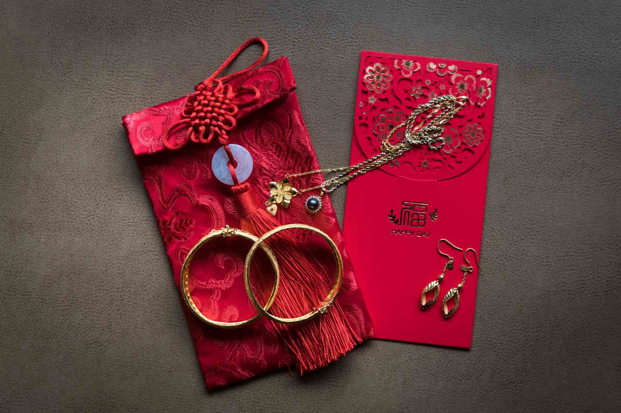 Gold jewelry on red fabric envelope with Chinese characters