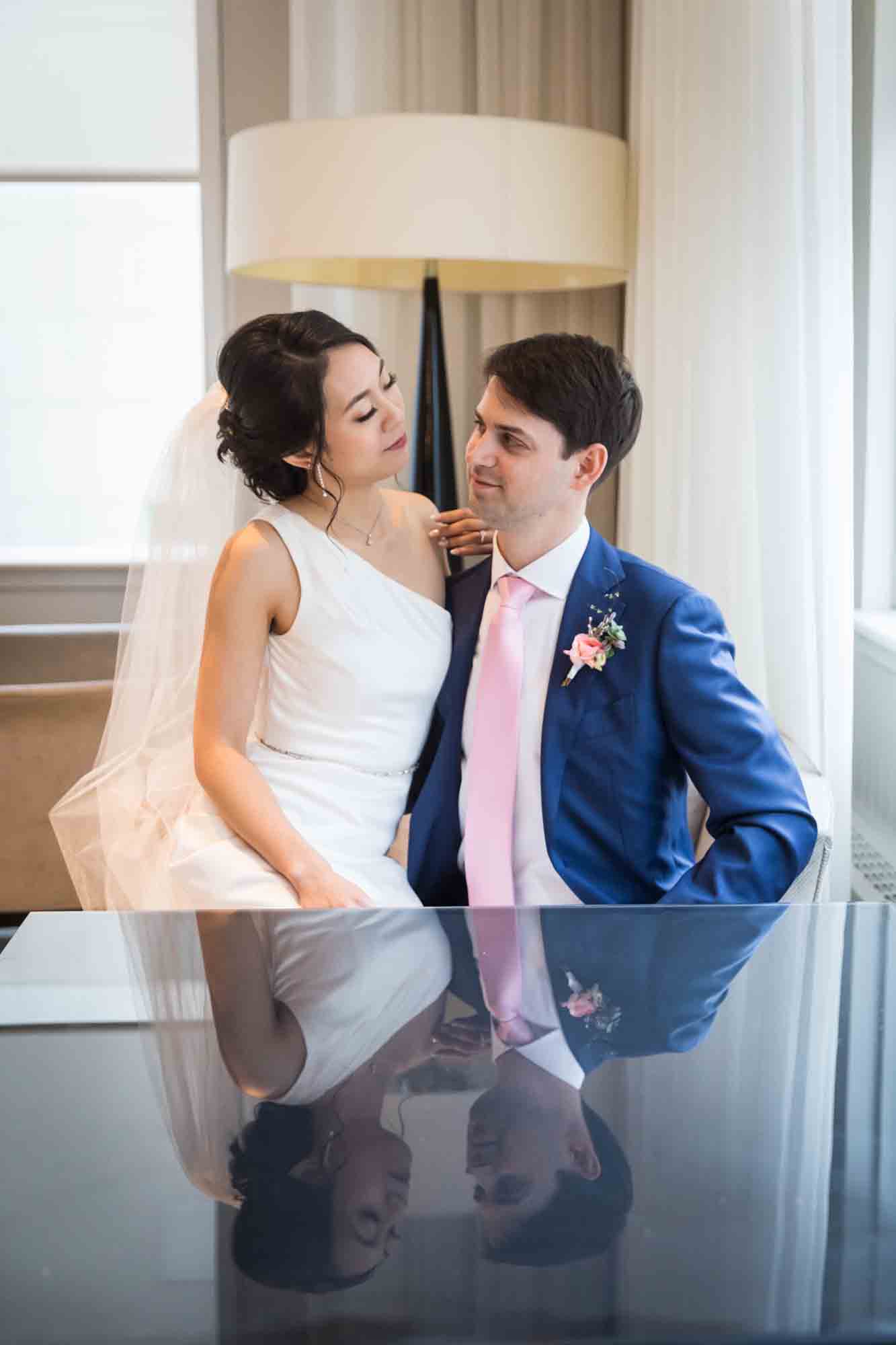 Bride and groom reflected in table top