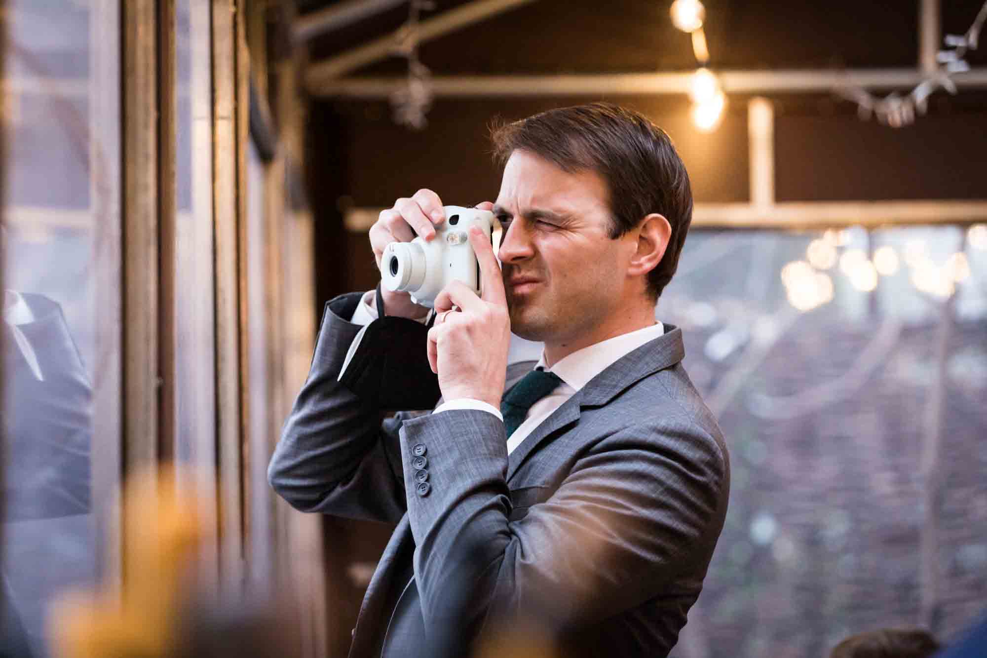 Guest taking photo at a Brooklyn restaurant wedding