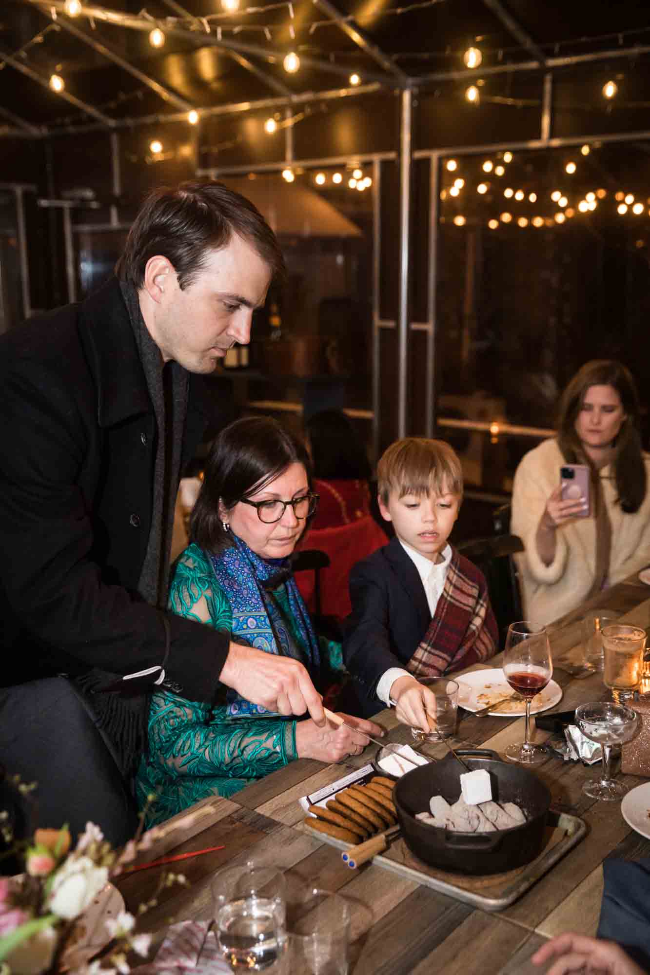 Guests eating s'mores at a Brooklyn restaurant wedding