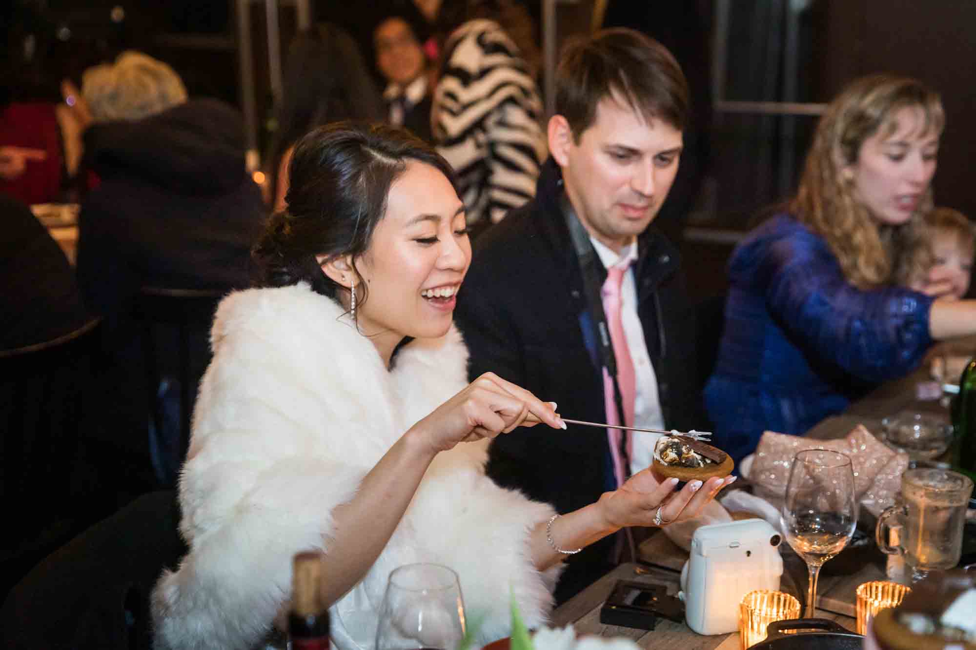 Bride and groom preparing s'mores at Olmsted restaurant