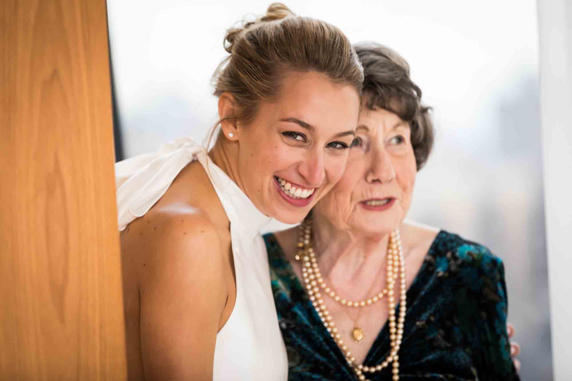 Bride smiling with older woman before a Public Hotel wedding