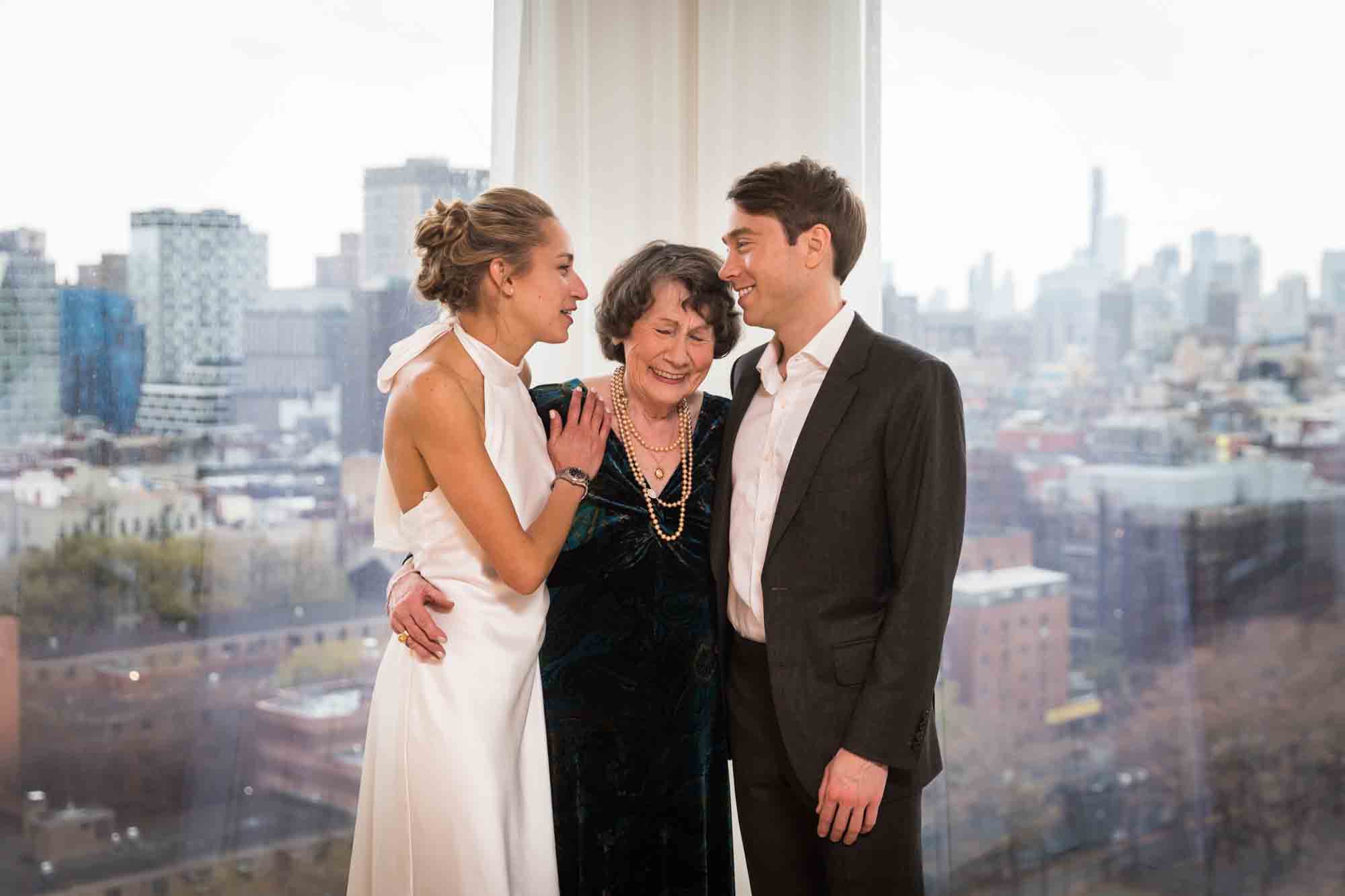 Bride and groom hugging grandmother before their Public Hotel wedding