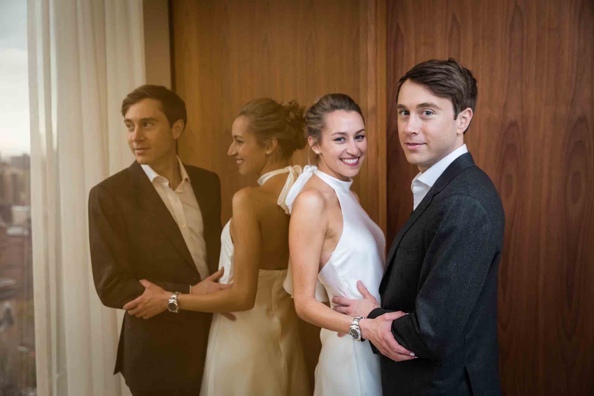 Bride and groom reflected in mirror for an article on how to plan a hotel room wedding ceremony