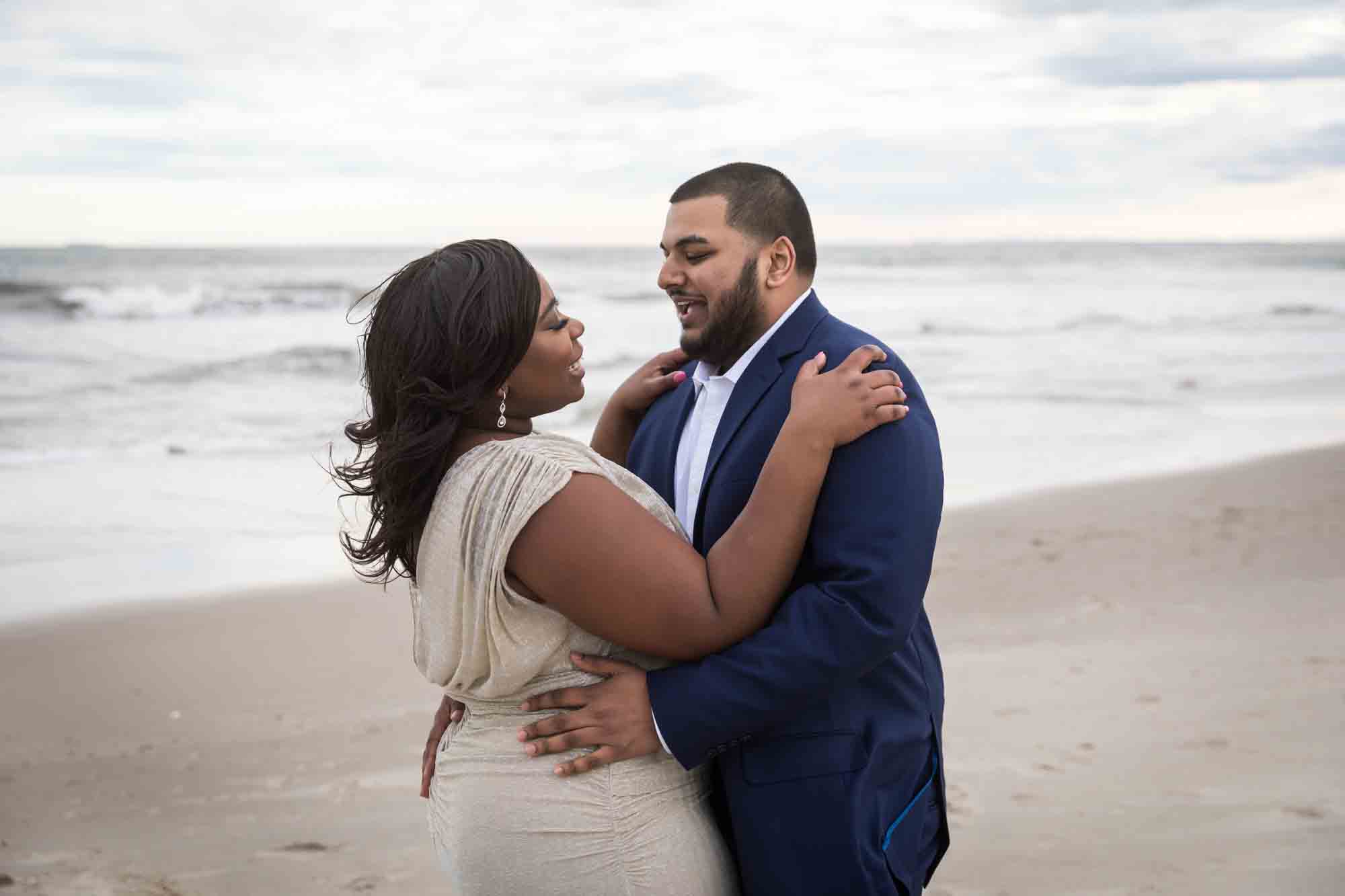 Couple dancing on the beach for an article on how to plan the perfect beach engagement photo shoot