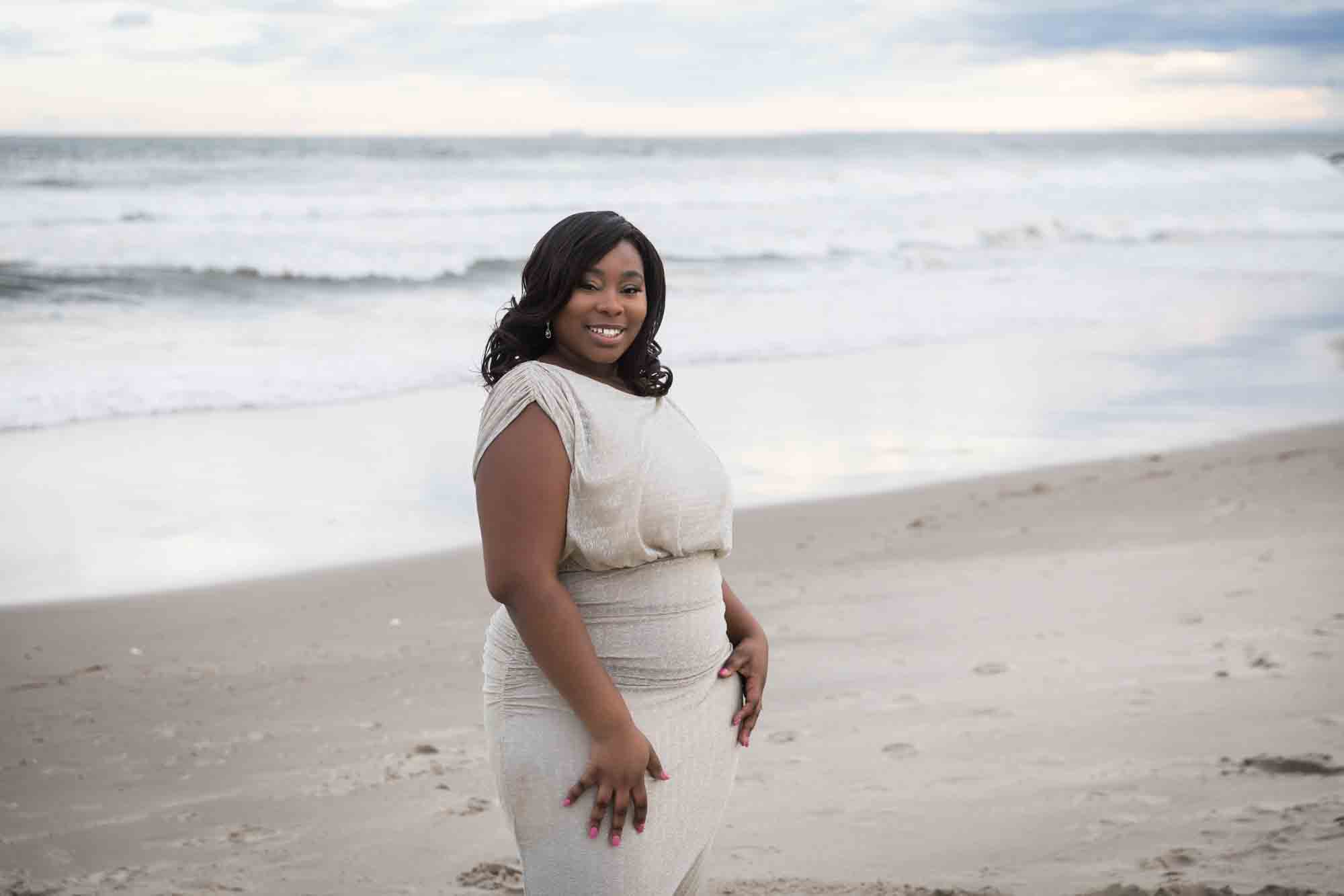 Woman wearing long beige dress on the beach