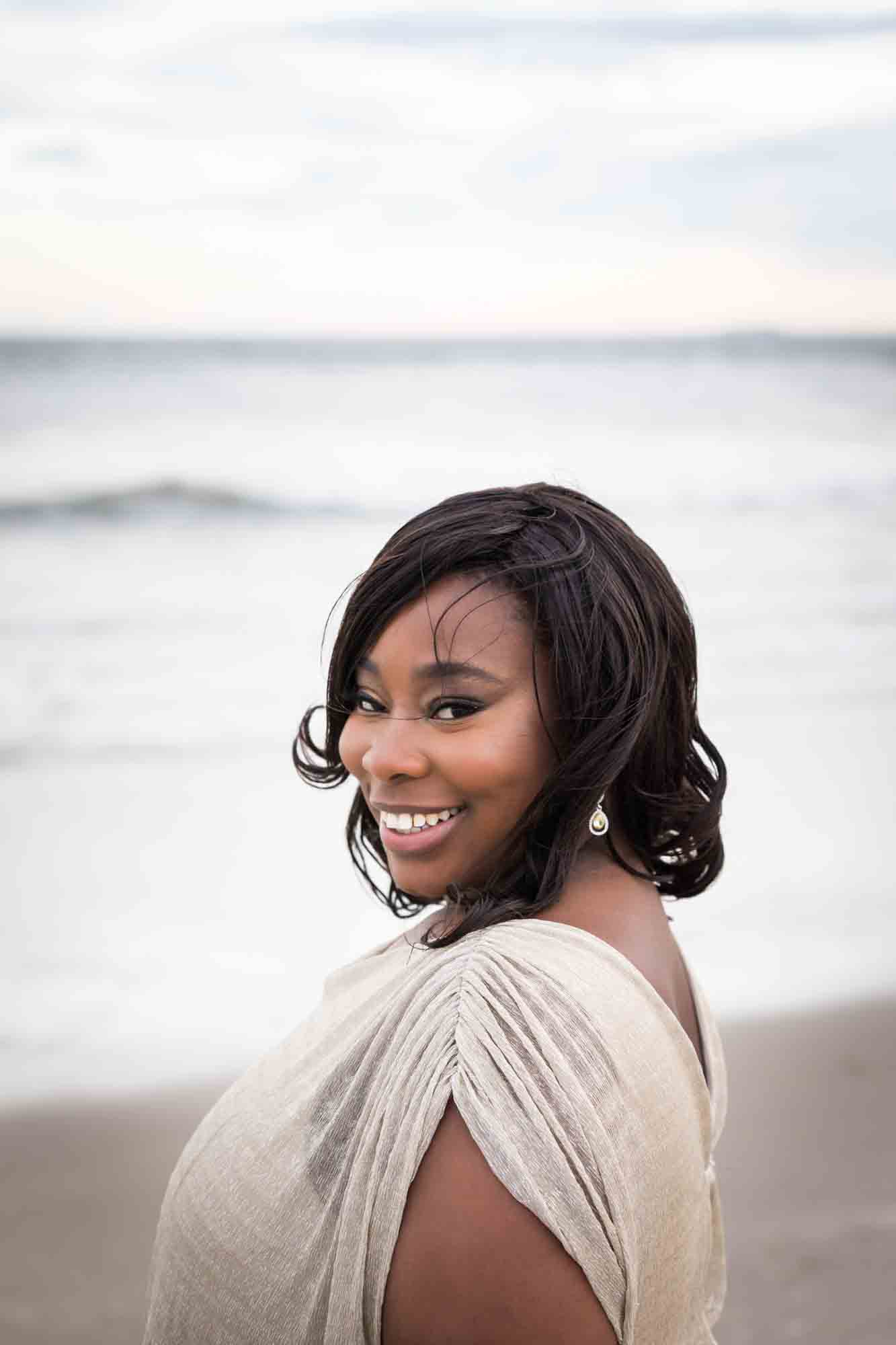 Smiling African American woman smiling in front of the ocean