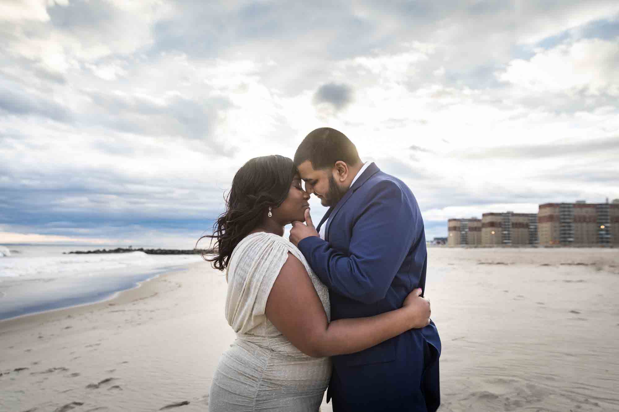 Couple pressing foreheads together on the beach
