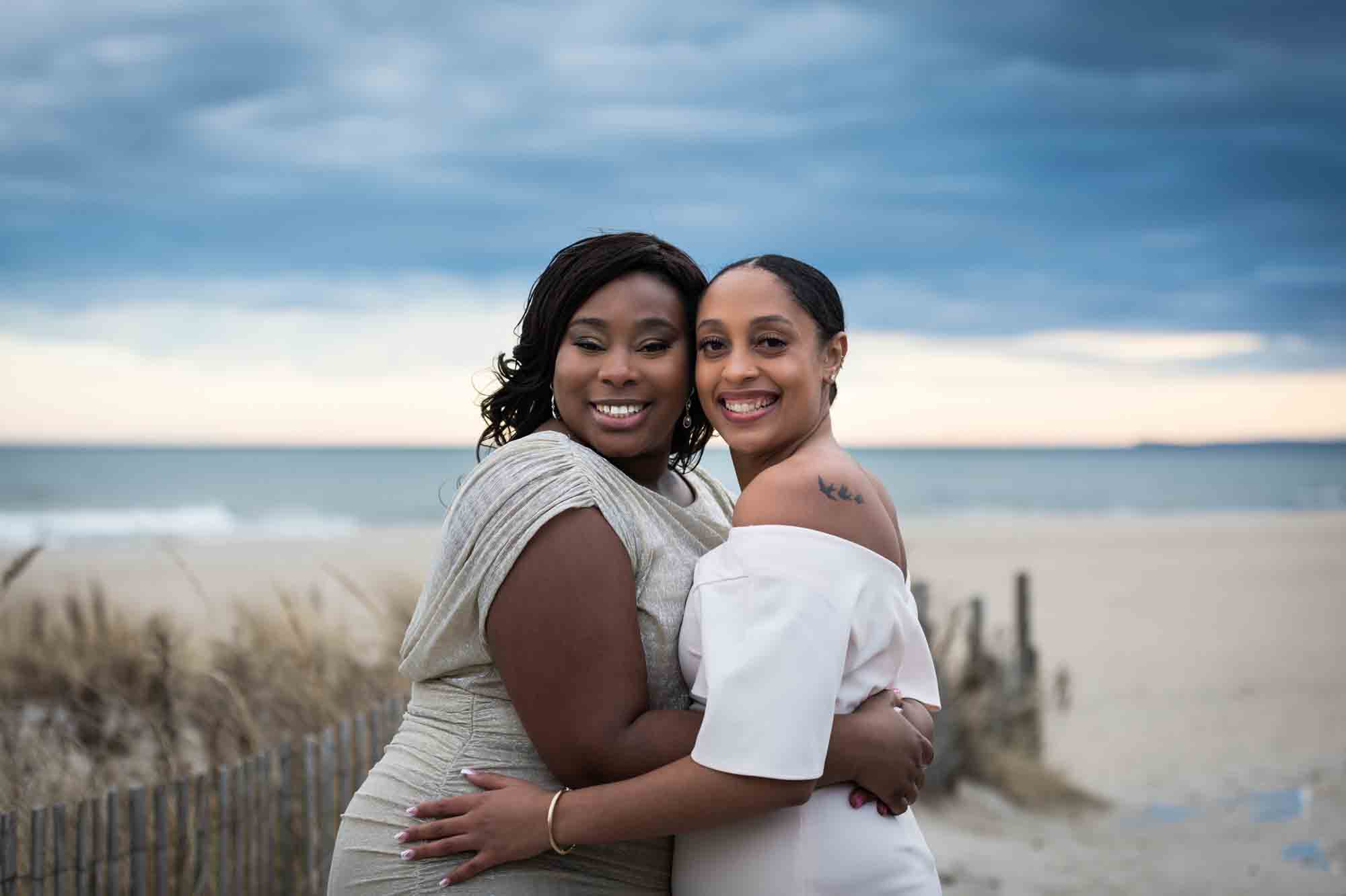 Two women hugging at the beach