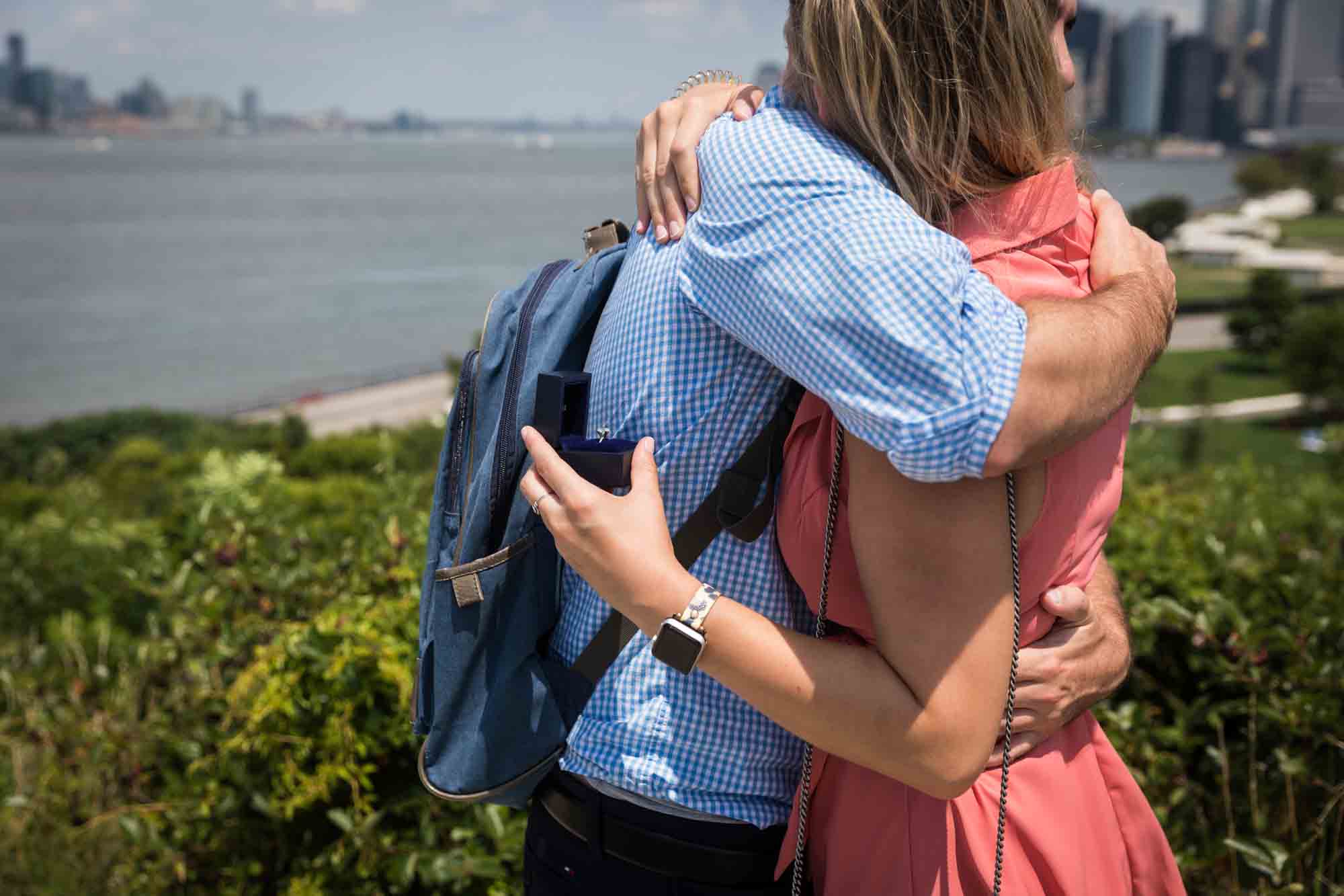 Couple hugging after propoeal for an article on how to propose on Governors Island