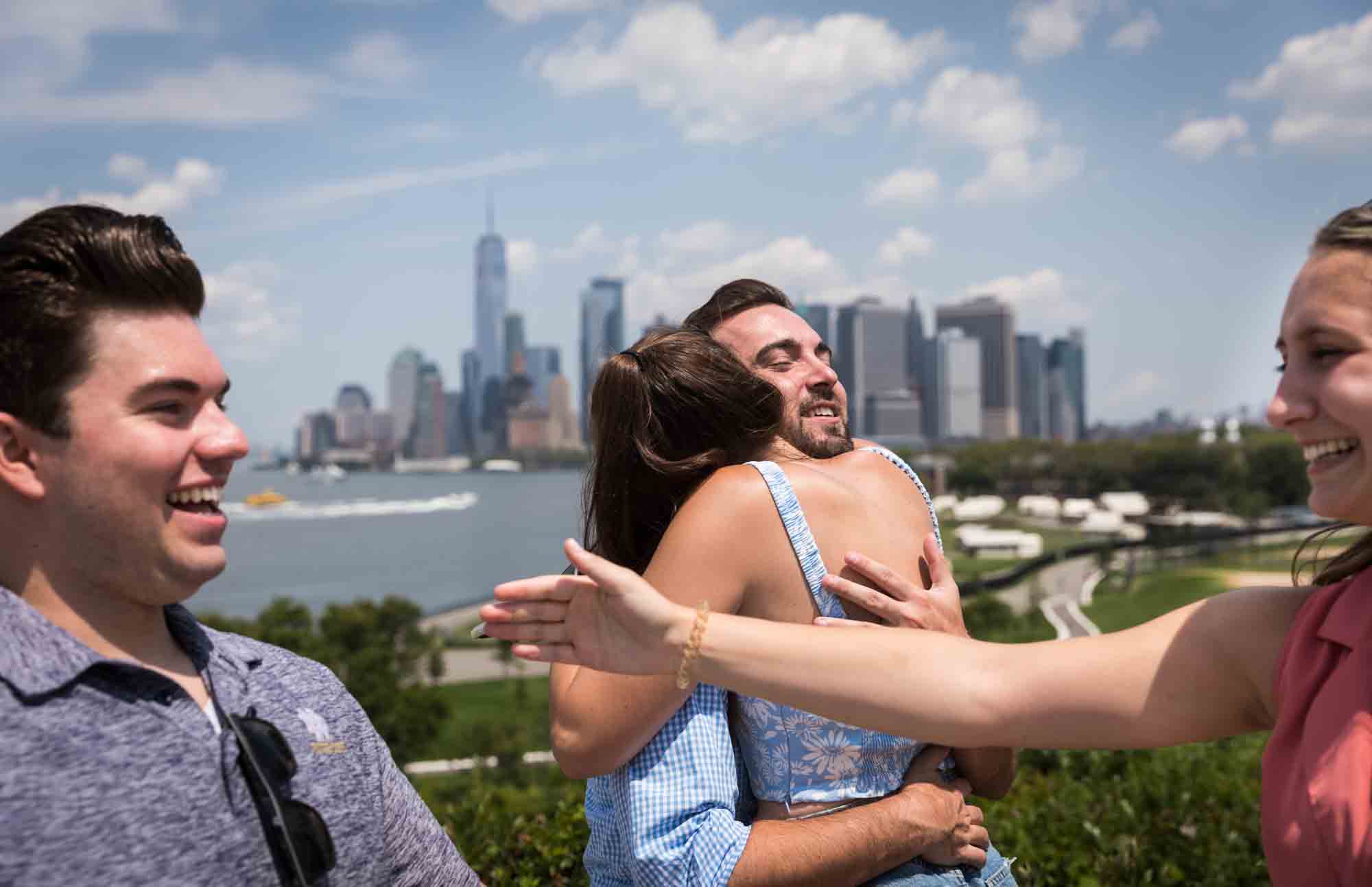 Man and woman hugging on Outlook Hill for an article on how to propose on Governors Island