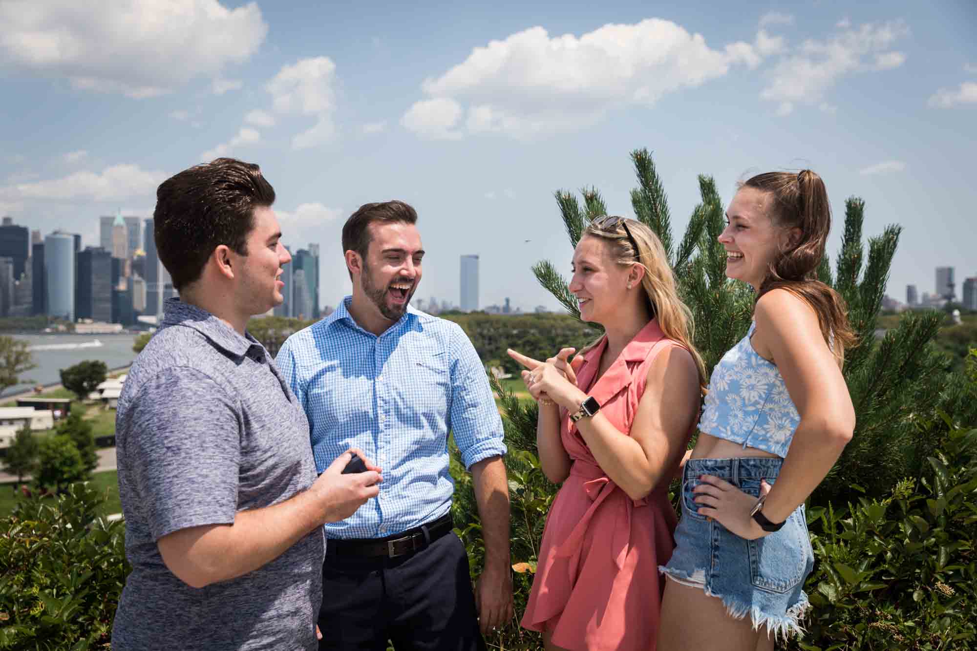 Two couples laughing after proposal for an article on how to propose on Governors Island
