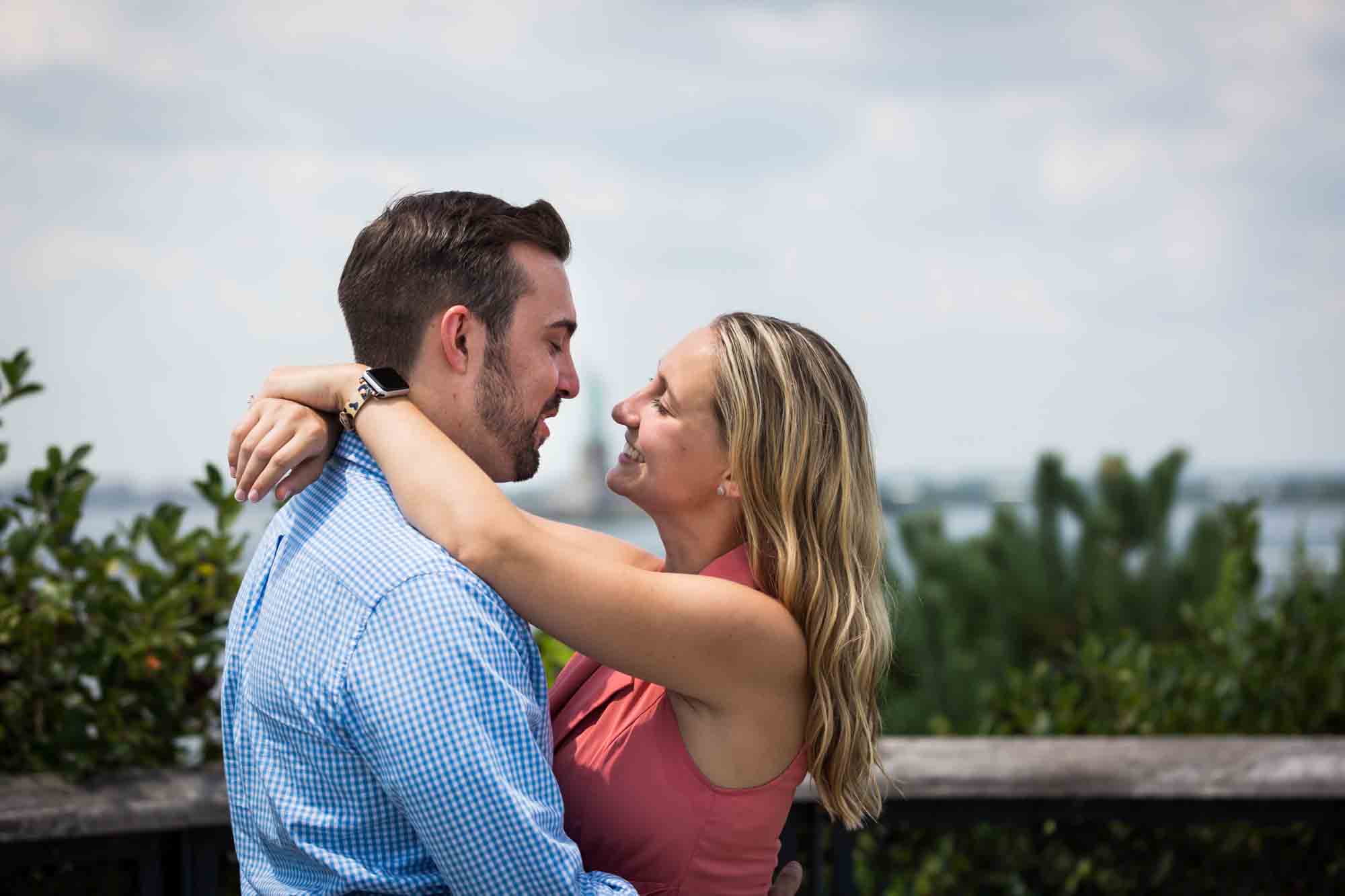 Couple looking at each other and hugging for an article on how to propose on Governors Island