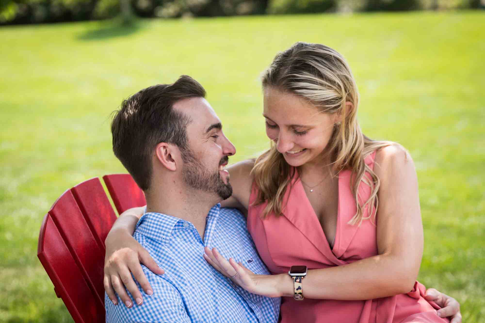 Couple sitting together on Adirondack chair