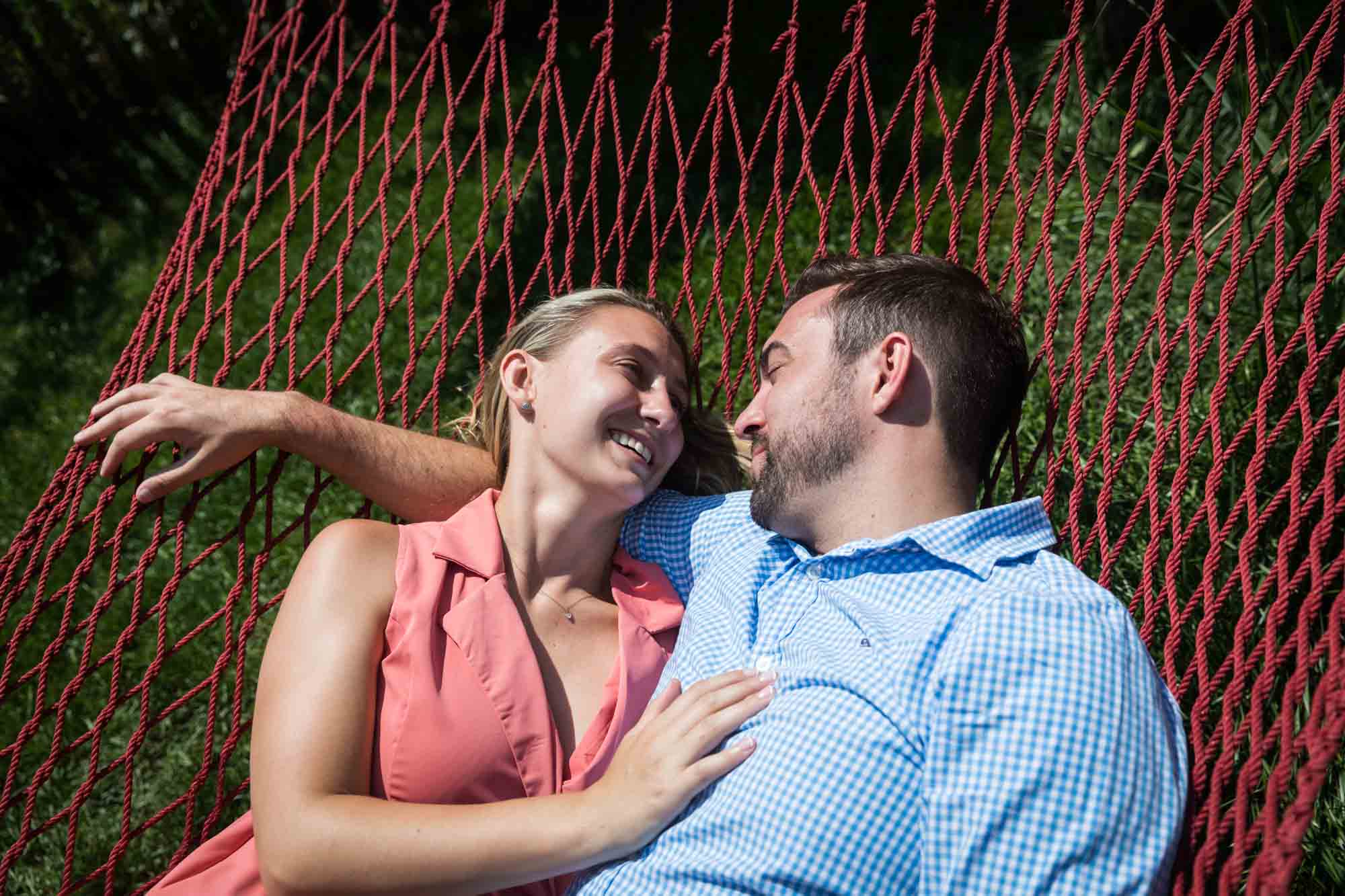 Couple lying on hammock for an article on how to propose on Governors Island